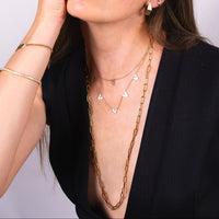 Women wearing the Venus Necklace, the Single Diamond Venus Necklace, the Fold-over Studs, and the Timeless Lariat 