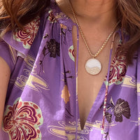 Close-up of a person wearing mother-of-pearl balance medallion 3mm box chain necklace