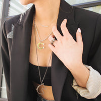 woman wearing the Black Diamond Horse Head Necklace, and the Silver Horseshoe Necklace