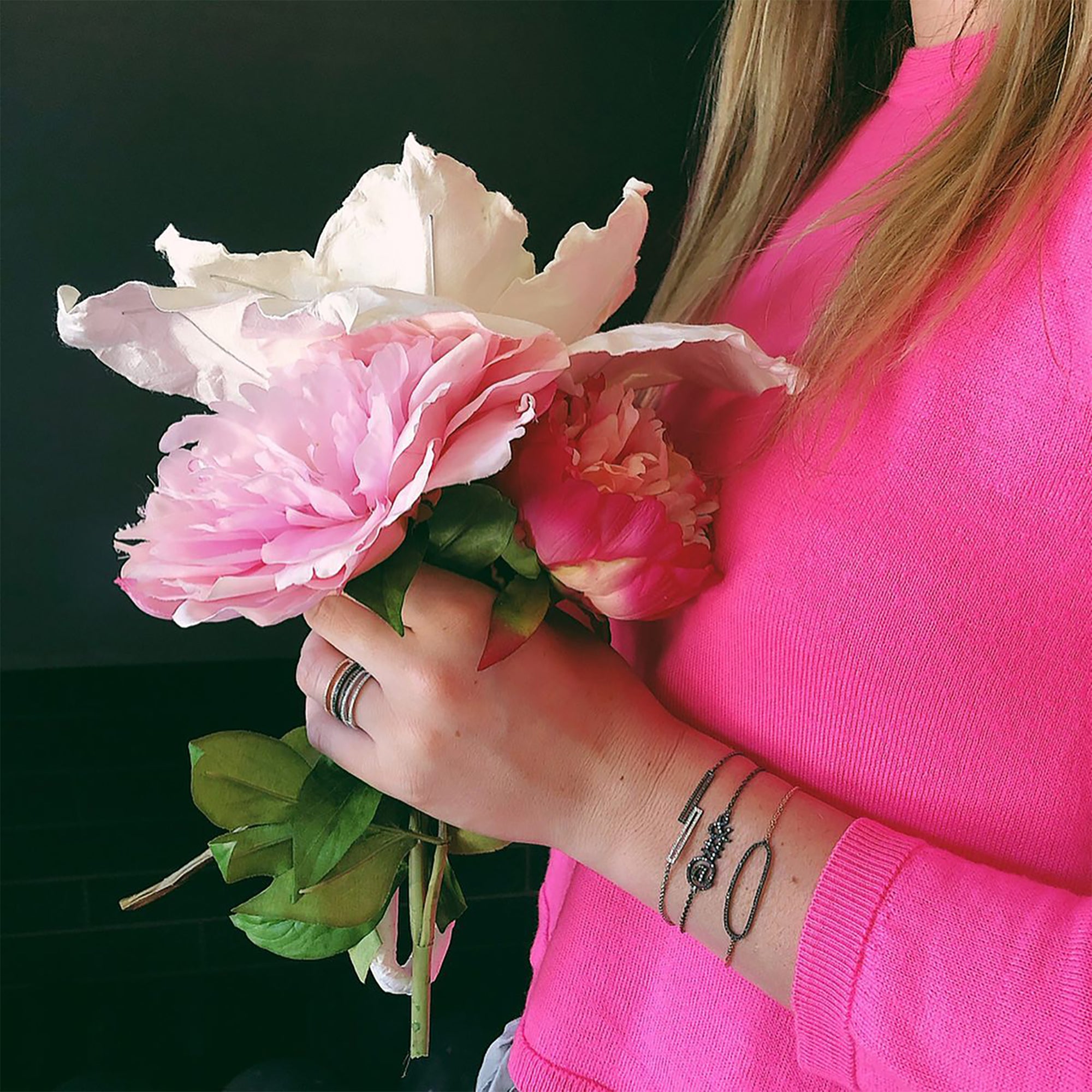 woman wearing the Black Diamond Open Bar Ring, the Diamond Open Bar Rings, the Ampersand Bracelet, and the Black Spinel Oval Bracelet