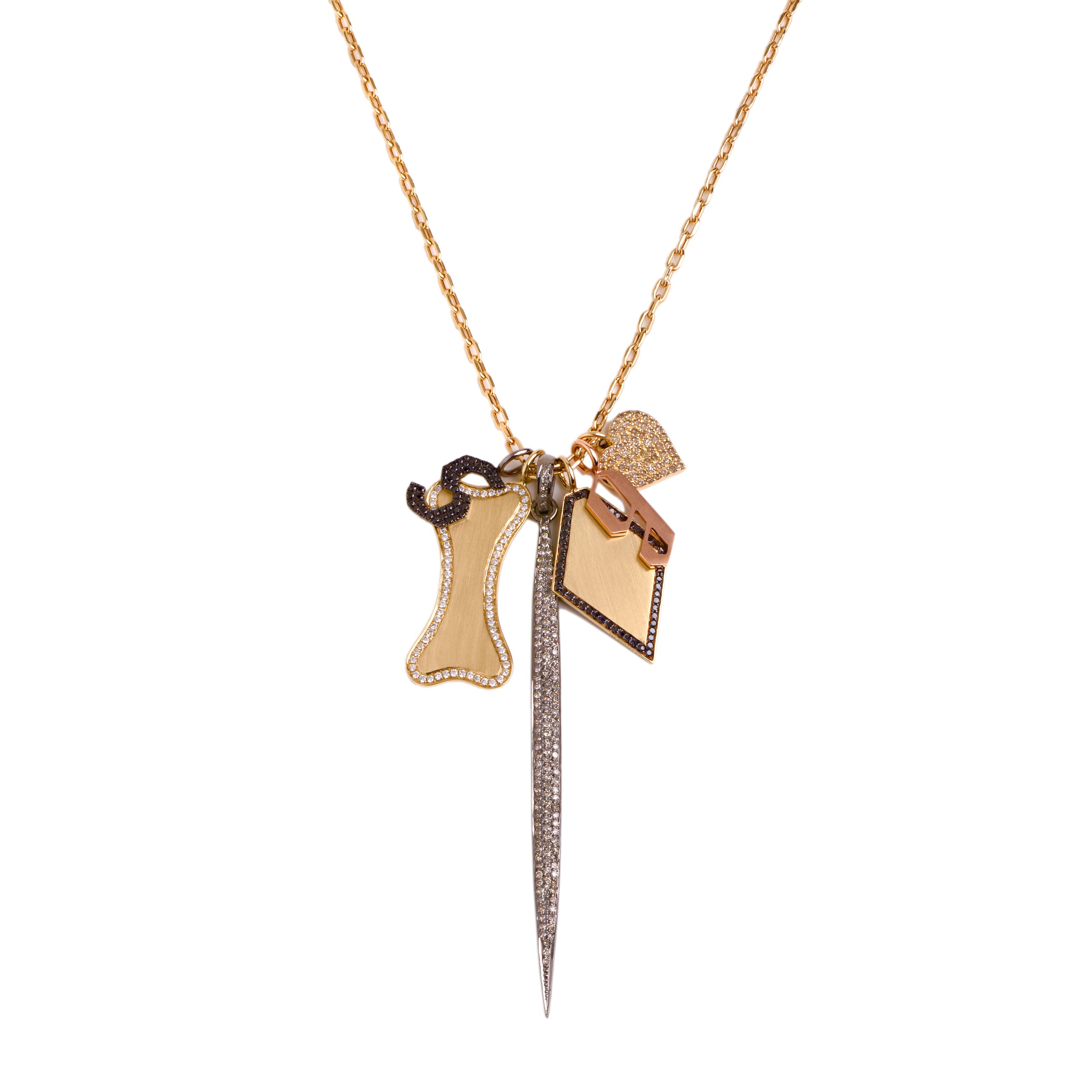 Dog Bone Charm Necklace: A 14K yellow gold charm necklace with a long link chain and six charms, including the Diamond Shaped Pendant with Black Diamond, the Large Diamond Dog Bone, the Silver 3" Champagne Diamond Spear, the 's' Small Black Diamond Alphabet Pendant, the 'g' Small Alphabet Pendant, and the  Diamond Heart Pendant