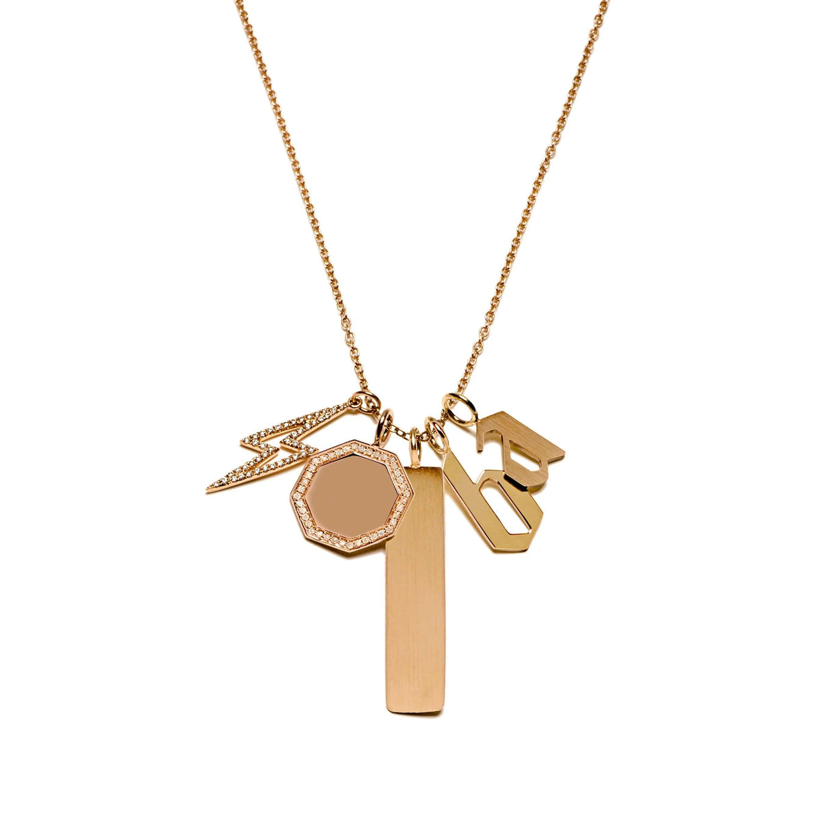 A charm necklace with the Dog Tag Pendant, the Starburst Diamond Pendant, the Small Alphabet Pendant, the Diamond Lightning Pendant, and the Octagon Diamond Pendant