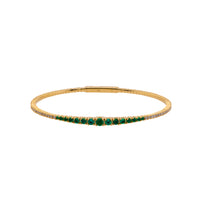 Emerald & Diamond Flexible Bangle: A 14K yellow gold bangle bracelet featuring emeralds and diamonds.
