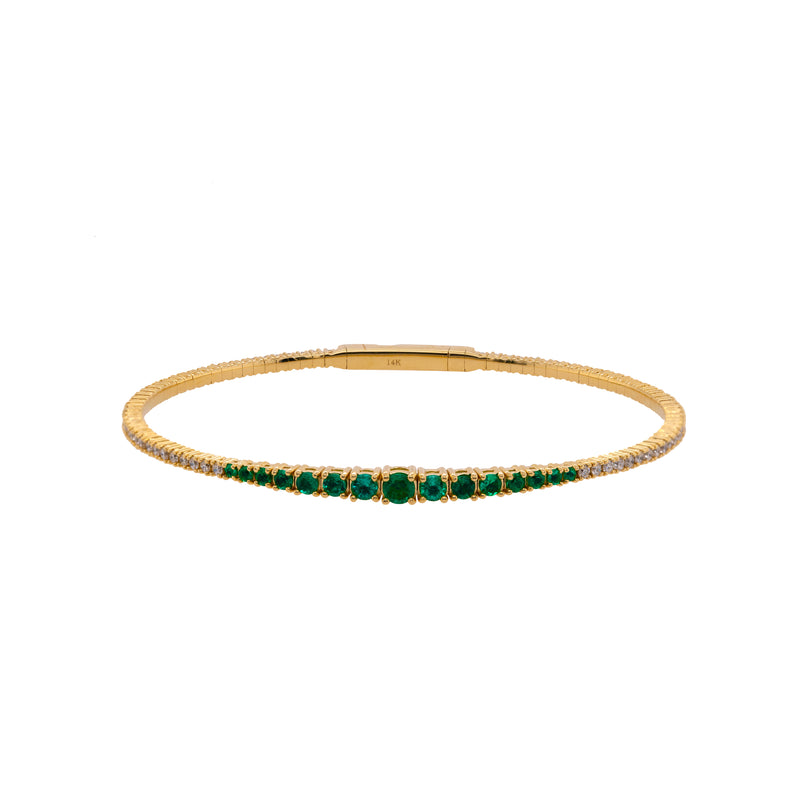 Emerald & Diamond Flexible Bangle: A 14K yellow gold bangle bracelet featuring emeralds and diamonds.
