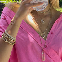 Woman wearing the Loving Life Heart Necklace, the Crystal Galaxy Necklace, the Starry Night Necklace, and the Timeless Necklace