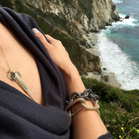 Woman wearing the Mesh Endless Bracelet, the Mesh Toggle Bracelet, and a Charm Necklace