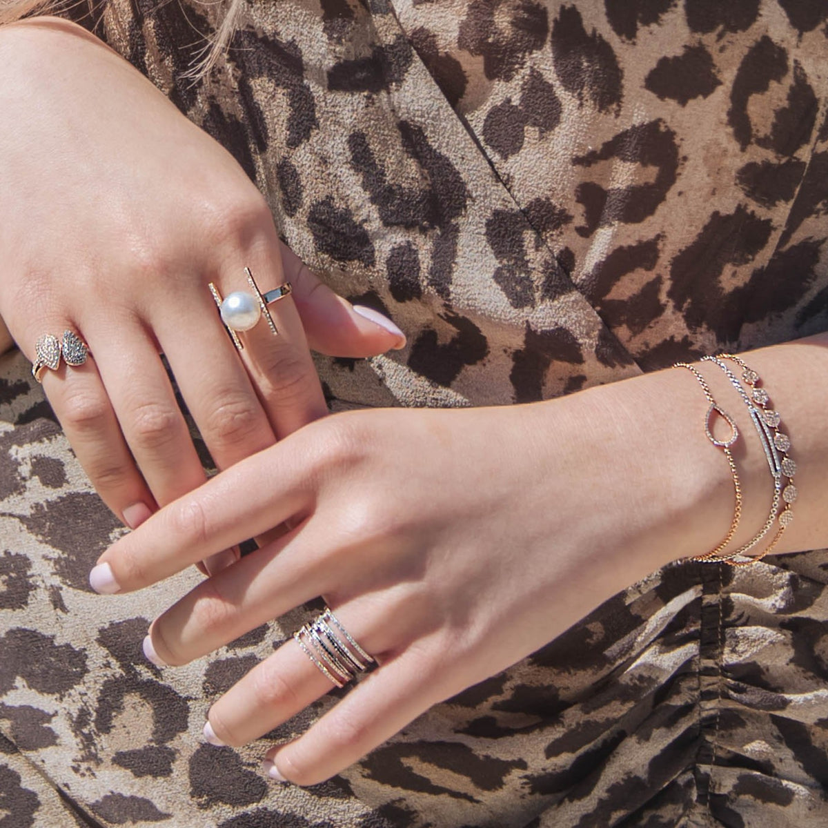 Close up of arms wearing the Mini Diamond Teardrop Bracelet, the Open Bar Diamond Bracelet