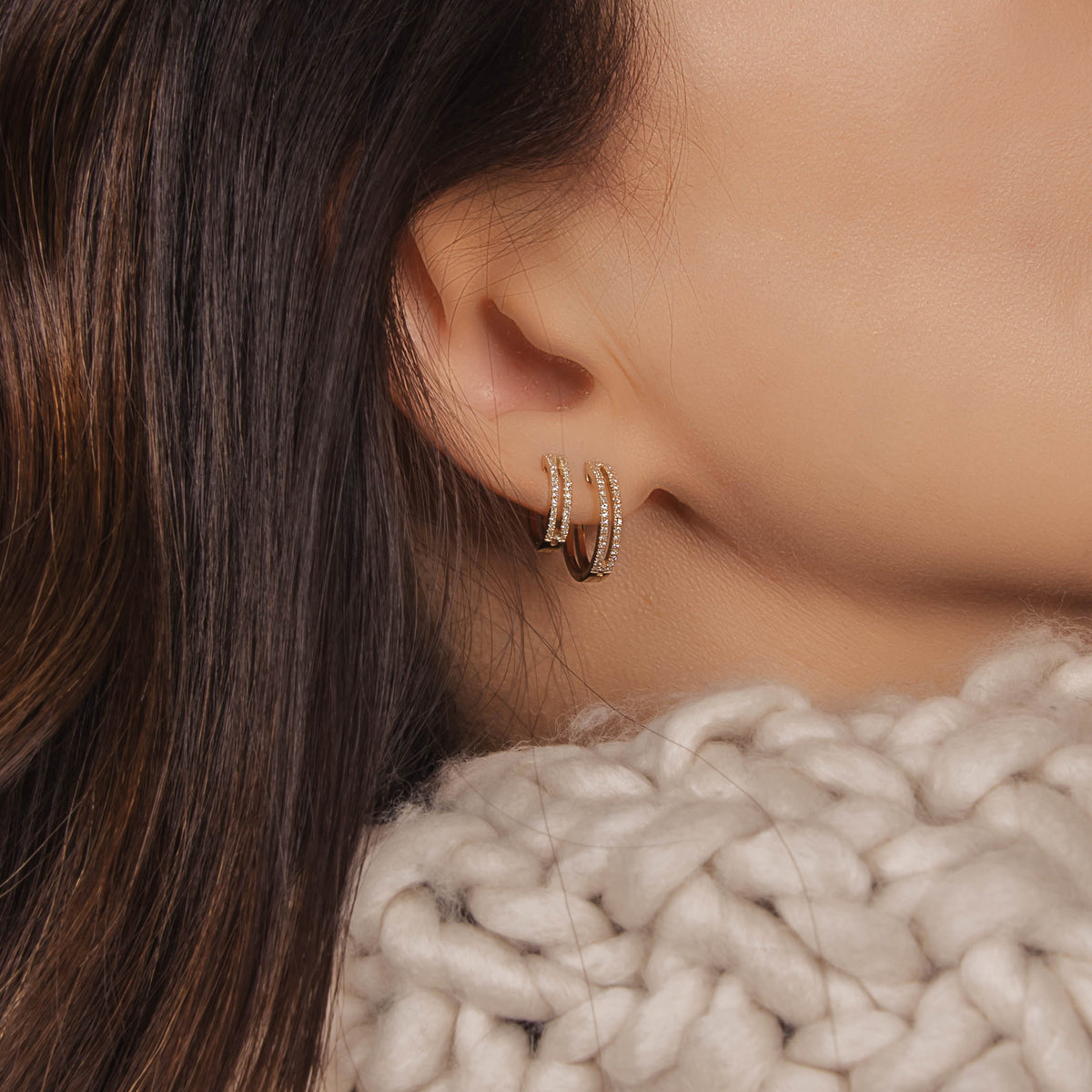 Woman wearing the Mini Open Bar Diamond Huggies and the Open Bar Diamond Huggies