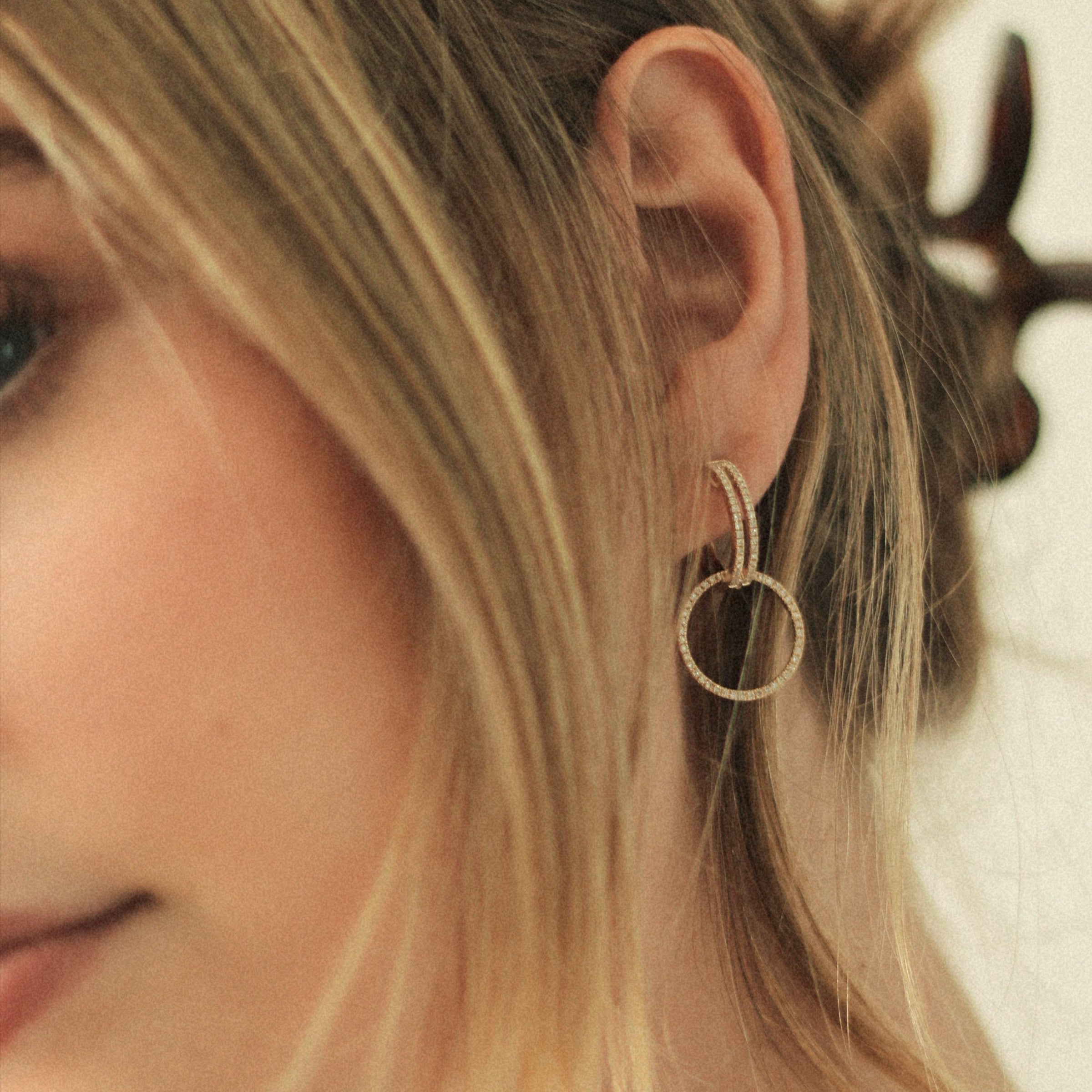 Close up of woman is wearing the Open Bar Diamond Huggies w/ Reversible White & Black Diamond Round Extensions