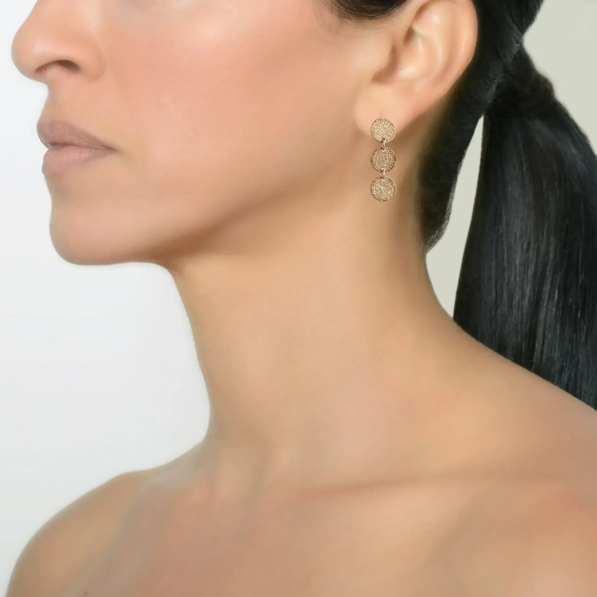 Rose Gold 3-Dot Earrings on a model
