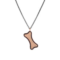 Rose Gold Large Black Diamond Dog Bone Necklace: A large 14K gold engravable dog bone pendant surrounded by black diamonds on a silver chain.