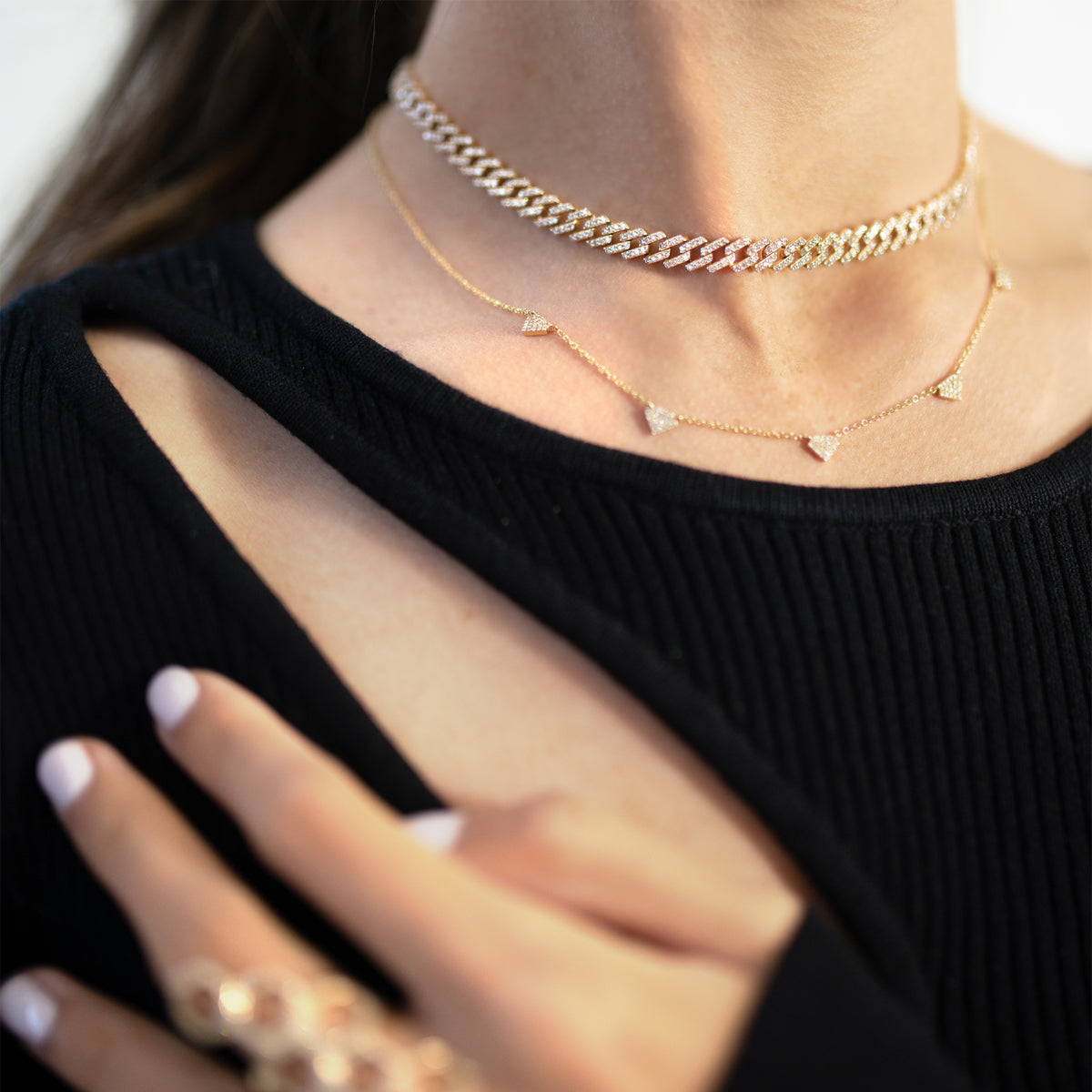 Close-up of a woman wearing the Shield Necklace, the Gaga Diamond Choker