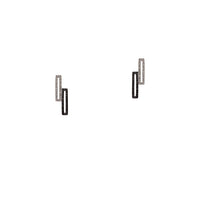 Staggered Open Bar Black & White Diamond Studs: A pair of stud earrings with a white and black gold design, featuring diamond accents.