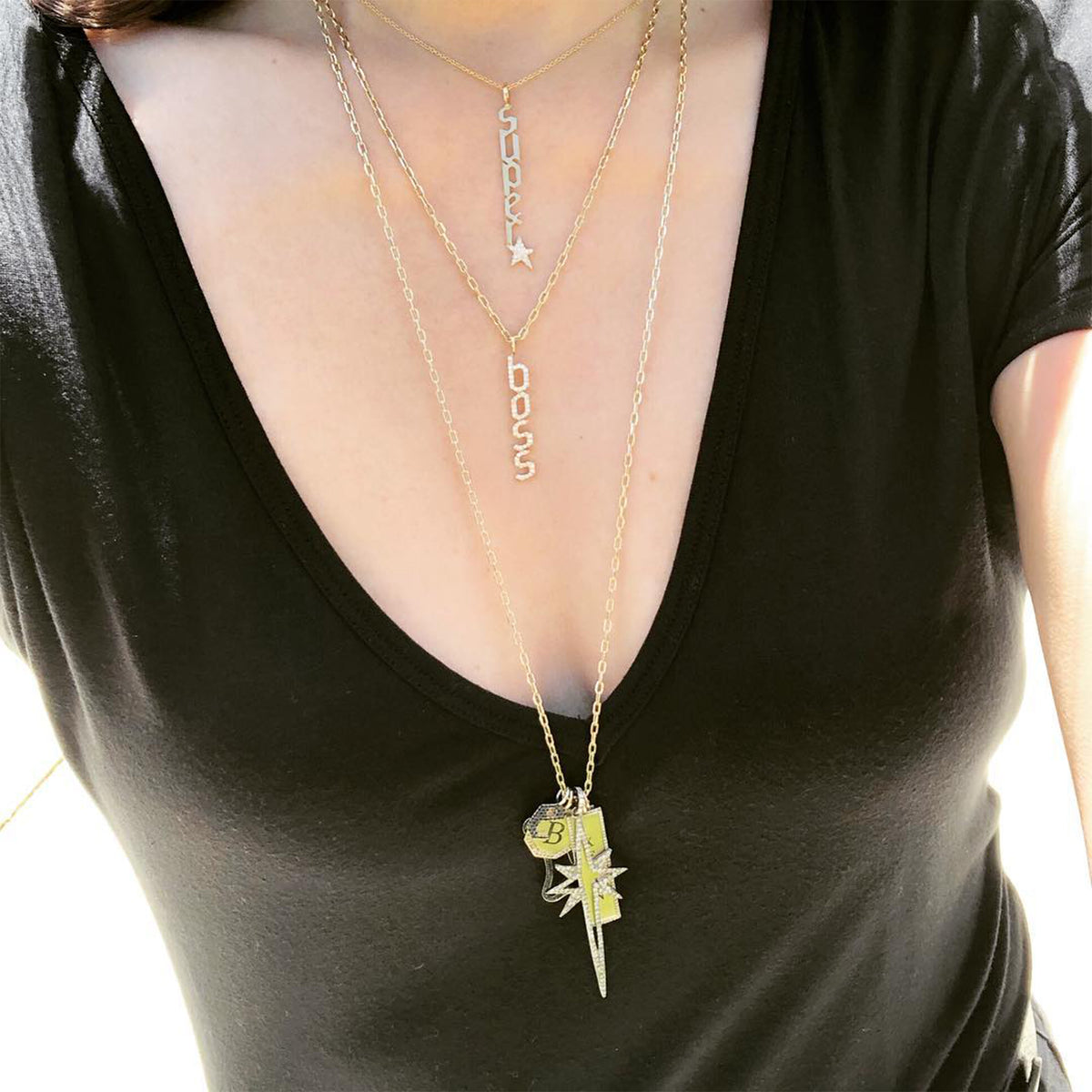 a woman wearing the Superstar Necklace, the Boss Necklace, and a Charm Necklace with 5 charms