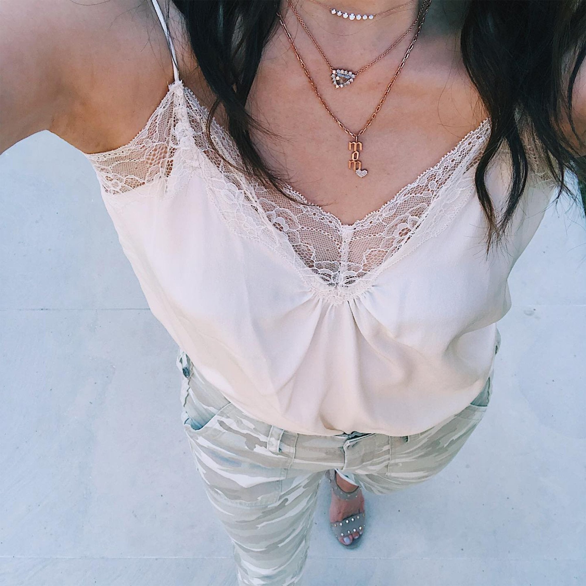 The woman is wearing the Mom Diamond Necklace 