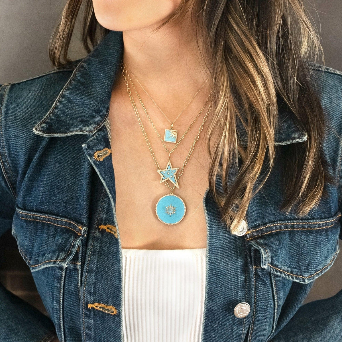 Woman wearing the Turquoise Halo Medallion Necklace, the Turquoise Shooting Star Necklace, and the Turquoise Another Dawn Necklace