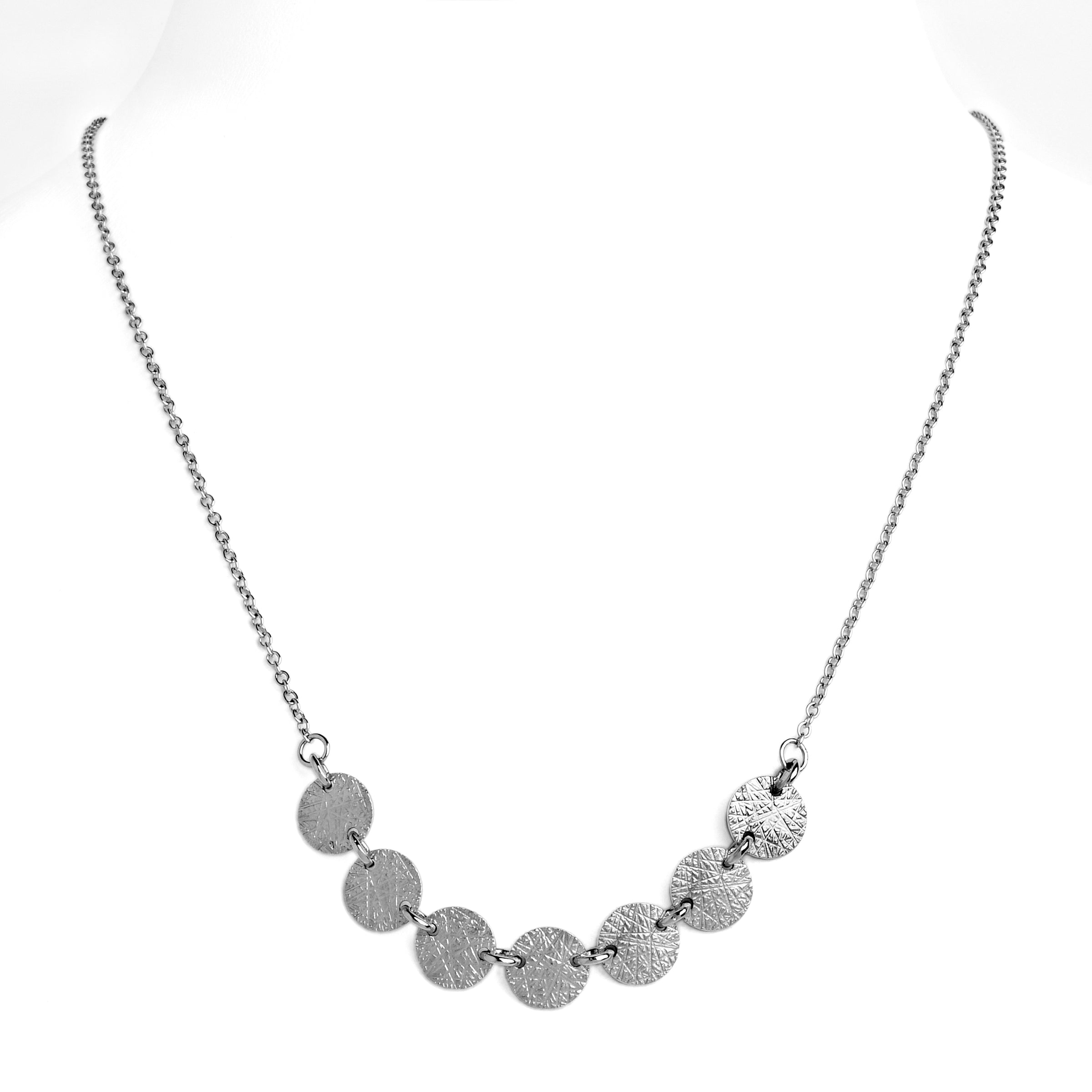 White Gold 7-Dot Necklace: A 14K gold necklace with a series of round charms connected by a chain.