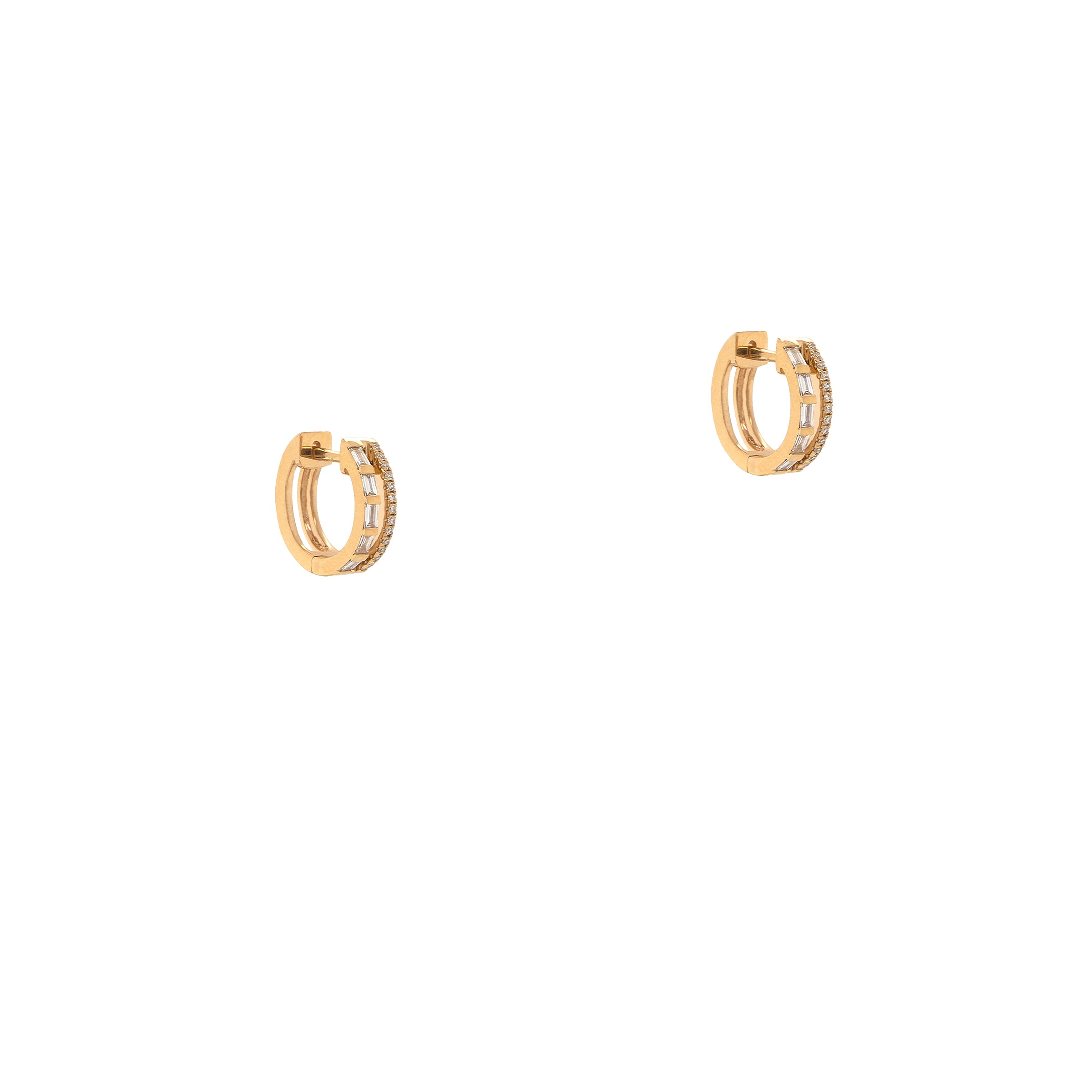 Deco Huggies: A pair of yellow gold huggie earrings with baguette and round diamonds set in them.