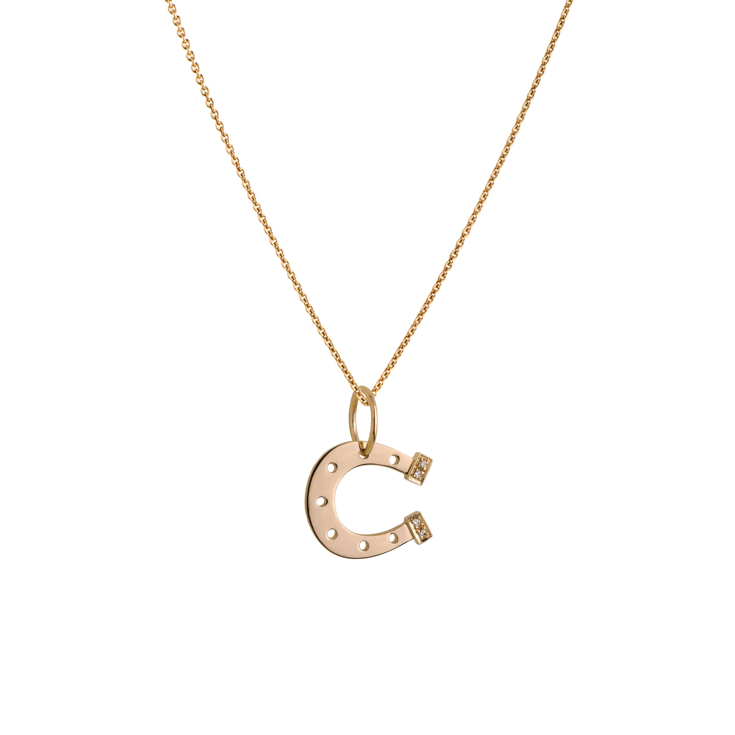 Yellow Gold Horseshoe Necklace: A 14K gold horseshoe-shaped pendant with small diamond heels on a chain.