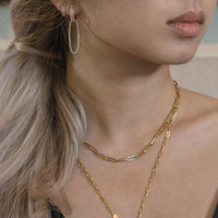 Woman wearing the Yellow Gold Open Bar Diamond Huggies w/ Reversible White & Black Diamond Oval Extensions, the Mini Open Bar Diamond Huggies, and the Timeless Choker
