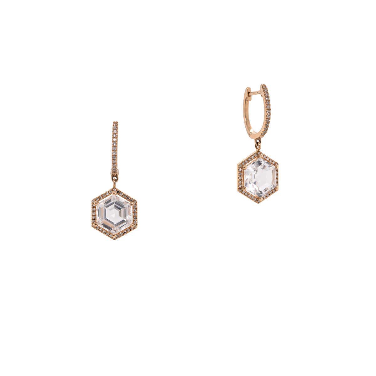 Yellow Gold Prism Hexagon Earrings: A pair of 14K gold earrings featuring drops of a white topaz gemstone in a hexagonal setting with smaller diamonds around it, attached to hinged huggies