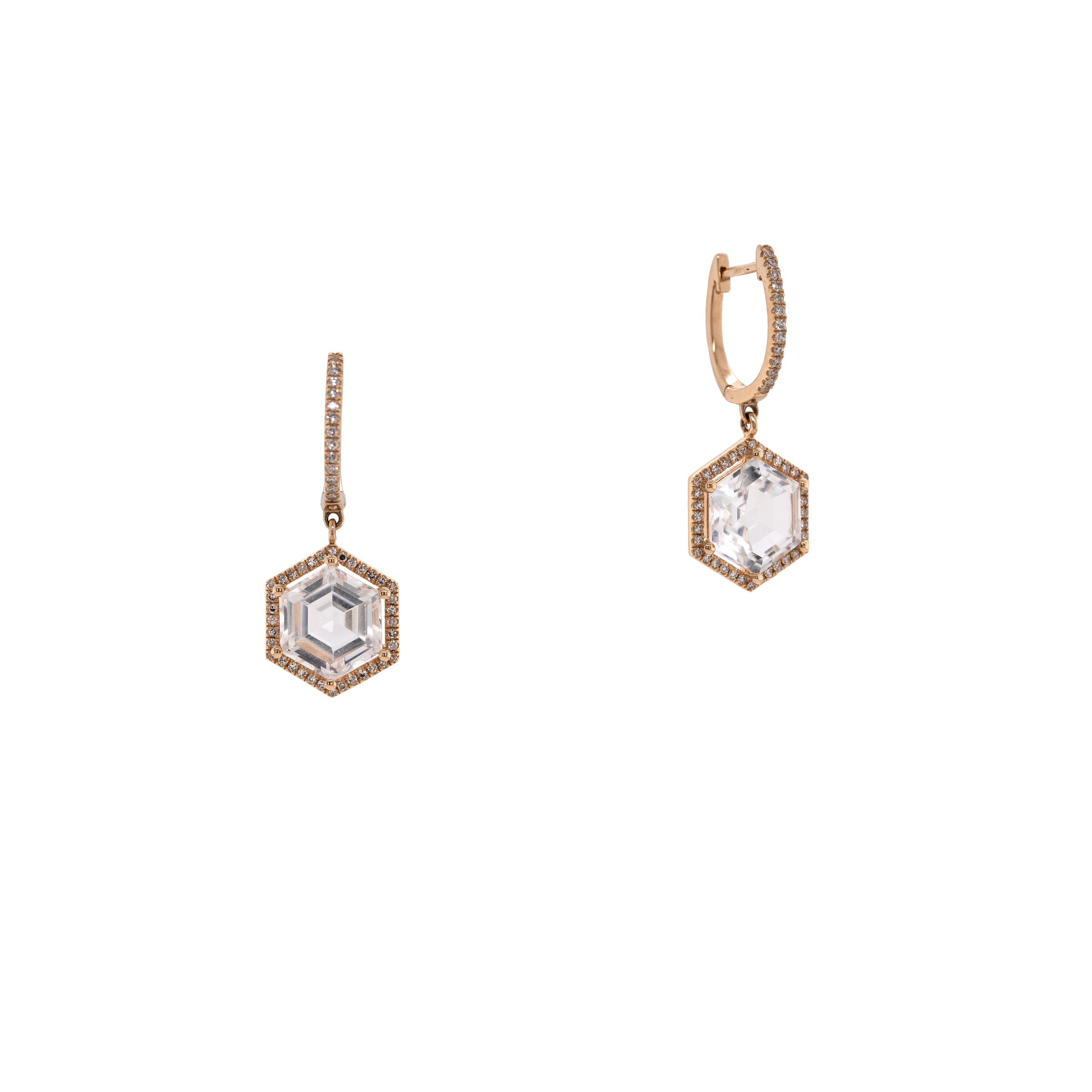 Yellow Gold Prism Hexagon Earrings: A pair of 14K gold earrings featuring drops of a white topaz gemstone in a hexagonal setting with smaller diamonds around it, attached to hinged huggies