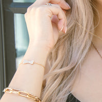 close up of ear wearing the Mini Diamond Dog Bone Bracelet